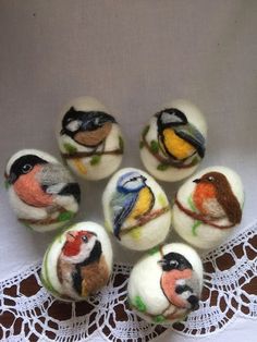 six needled birds sitting on top of white balls