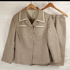 This piece is in good condition commensurate with age and long-term storage. It is structurally sound and both pieces are fully lined. The blazer features original buttons, two breast pockets, and two hip pockets. The skirt features hanger straps, button / zip closure, and front / back pleats. See photos for details. The suit is tagged as a size 44, but Vintage sizes can run very small. Check measurements below before purchasing. *bust, waist and hip measurements taken flat and doubled* ~ Blazer Workwear Sets With Buttons And Lapel Collar, Workwear Sets With Lapel Collar And Buttons, Classic Workwear Sets With Pockets, Classic Office Sets With Button Closure, Classic Fall Sets With Pockets, Vintage Office Skirt Suit With Buttons, Classic Notch Lapel Skirt Suit With Buttons, Vintage Skirt Suit With Buttons For Office, Classic Skirt Suit With Notch Lapel