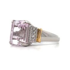 The star of this show is a stunning 9.64 carat emerald cut Kunzite. The soft pink hue of the center stone make it easy to accessorize. Adding to the glamour are six sparkling natural round brilliant cut diamonds, three on each side of the center stone. The platinum setting provides a polished backdrop for the Kunzite while and the 18 karat yellow gold accents on the shoulders add a touch of warmth to the overall design. Luxury Pink Diamond Gemstone Ring, Luxury Pink Diamond Ring For Formal Occasions, Luxury Pink Morganite Jewelry, Luxury Rings With Baguette Cut Gemstone Accents, Luxury Pink Rings With Brilliant Cut, Luxury Pink Rings With Center Stone, Pink Luxury Rings With Center Stone, Luxury Pink Brilliant Cut Rings, Formal Pink Diamond Ring With Gemstone