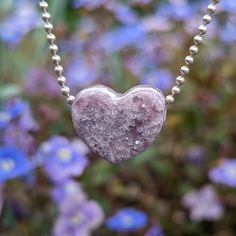 This Lepidolite was hand carved me into a heart shaped pendant. I got from Stone Haven Gems and it was mined in Madagascar! This pastel purple has literal flakes of sparkles throughout! Really cool! Wear alone, or pair with another with and a shape in the middle - make your necklace as unique as your are! The last image is a sample of this style paired with others for a visual reference. If you are looking to build your own necklace with 'wings', I recommend pairing with something that is close in dimension! If you have trouble envisioning a necklace, don't hesitate emailing me at gotstonedjewelry@gmail.com with the listing links and I will send you a picture of what it looks like :) If you decide on a chain, it will be 925 silver 1.5mm ball chain, shown in the images. If not, it will come Silver Heart Jewelry With Gemstone Beads, Silver Heart-shaped Gemstone Beads Jewelry, Silver Heart-shaped Jewelry With Gemstone Beads, Purple Heart-shaped Jewelry With Natural Stones, Heart-shaped Crystal Necklace With Natural Stones For Healing, Heart-shaped Natural Stone Crystal Necklace For Healing, Spiritual Crystal Necklace With Heart Charm, Handmade Heart-shaped Crystal Necklaces For Healing, Handmade Heart-shaped Crystal Necklace For Healing