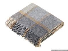 a grey and tan plaid blanket with fringes on the bottom, against a white background