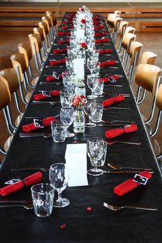 a long table is set with glasses and place settings