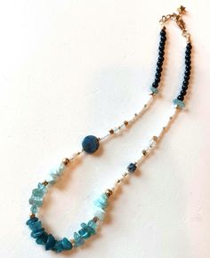 So many pretties in this choker necklace! 💙 Blue/green apatite chips, round and square stone beads  Ocean blue Larimar stone chip beads 🤍 Freshwater pearls 🤍 Crackle clear agate round stone beads 🤍 White Japanese glass seed beads 🖤 Black agate round stone beads Gold plated clasp chain and spacer beads. Can be worn alone or layer with your own gold chain necklace or with other gemstone necklaces! Adjustable to 16" inches. Gemstone Choker Necklace, Green Apatite, Gemstone Choker, Larimar Stone, Gemstone Necklaces, Square Stone, Black Agate, Chip Beads, Choker Necklaces