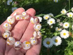 Lovely cute vintage Murano millefiori beads from an uncirculated stock in Venice. These vintage Venetian millefiori beads are great for collectors and for jewelry makers! These daisy beads are so sweet! ✔️Shape: round ✔️Finish: shiny ✔️Color: cristal clear glass with white and yellow daisies ;) ✔️Size: ca 12 mm. These beads are handmade, each bead is different. Beads will be randomly picked. ✔️1970-1980 ✔️Perfect condition. From an old stock in Venice. This is the real thing, no Chinese or India Murano Glass Bead Jewelry, Handmade Clear Beaded Bracelets With Round Beads, Handmade Clear Beaded Round Bracelets, Handmade Clear Beaded Bracelets, Handmade Clear Round Beaded Bracelets, Handmade Clear Beaded Bracelets As Gift, Millefiori Bead Necklace, Handmade Vintage Jewelry In Murano Glass, Daisy Beads