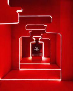 a red room with an illuminated bottle in it