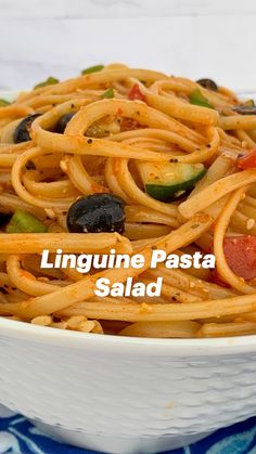 linguine pasta with olives and peppers in a white bowl