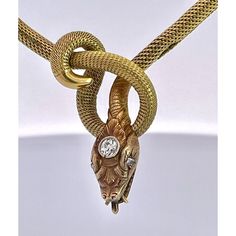 This is part of Chairish’s Fine Jewelry assortment.  This piece is from the early 1900's and is very special as it is longer than most snake necklaces. Women were much smaller then, so most are 13" to 15" necklaces.  This necklace is 16" plus the drop for the snakes head. Perfect for most women. This snake has a beautiful carved and detailed face with a 0.20 point Diamond on his head. This is marked 750 and weighs in at 24.62 grams of gold.  I just love snake jewelry as many of you now but seldom do I purchase these snake necklaces because they are too small for most.  Unless they are 16" or better I let them go.  This one fits the bill as it is 16" plus the drop for the snakes head. Vintage Yellow Gold Diamond Necklace For Formal Occasions, Vintage Gold Diamond Necklace For Formal Occasions, Antique Snake-shaped Yellow Gold Jewelry, Antique Gold Diamond Necklace For Formal Occasions, Antique Gold Snake-shaped Jewelry, Luxury Snake Shape Necklace For Formal Occasions, Luxury Formal Snake Shape Necklace, Luxury Yellow Gold Snake Necklace, Elegant Engraved Snake-shaped Jewelry