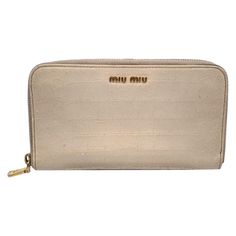 Miu Miu Zippy Wallet crafted in light beige embossed leather. Zip closure. It features 2 main compartments for bill, 2 flat open pockets, 1 zip coin compartment, 8 credit card slots. Gold metal MIU MIU lettering on the front. 'Miu Miu' and 'Made in Italy' engraved inside. Details MATERIAL: Leather COLOR: Beige MODEL: n.a. GENDER: Women COUNTRY OF MANUFACTURE: Italy SIZE: Medium TYPE: Wallet YEAR MANUFACTURED: 2010-2019 DUSTBAG? No BOX? No KEYS? No Condition B - VERY GOOD Gently used. Some light Miu Miu Evening Bag With Zipper Closure, Miumiu Wallet Pink, Brown Miu Miu Shoulder Bag With Gold-tone Hardware, Miu Miu Formal Shoulder Bag With Gold-tone Hardware, Miu Miu Brown Bag With Gold-tone Hardware, Wallet Craft, Chanel Vintage, Small Accessories, Light Beige