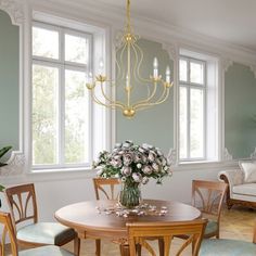 a dining room table with chairs and a chandelier