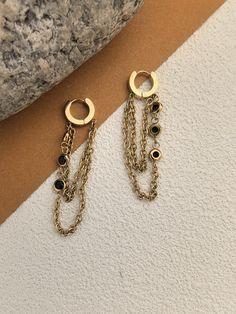 🌟 Indulge your luxurious side with our Black Zircon Chain Drop Earrings. Handmade with delicate chain links, these 18K gold plated earrings feature stunning black zircon stones that add a touch of sophistication to any outfit. Perfect for adding a statement to your look and as a stunning gift for her. * 2 1/4" (55mm) drop * 1/2" (13mm) width * Hinge with snap-post closure * Stainless steel, zircon * 14k-gold plate 🌟 Helpful info: Protect your precious jewelry by keeping it away from water and Tarnish Resistant Dangle Hoop Earrings, Gold Plated Round Earrings With Dangling Charms, Chain Drop Earrings, Chain Links, Delicate Chain, Etsy Earrings Dangle, Precious Jewelry, Gold Plated Earrings, Earrings Handmade