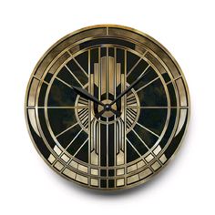 a black and gold clock with an art deco design on the face, against a white background