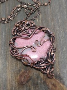 The pendant is made with solid copper wire and circle shaped rhodonite gemstone. I made the flat wire myself. Chain is also solid copper with adjustable length (18 - 20 inches or 45 - 50cm), I can change it on request. The color of the gemstone is a nice soft pink, the brightest pink I ever found for the rhodonite. Also there are some light grey veins which make it more interesting. Pendant is relatively big but lightweight. The shape of the wire-wrapping reminds a heart. The height of the pendant is about 5 cm or 2 in. Rhodonite is a stone of compassion, an emotional balancer that clears away emotional wounds and scars from the past, and that nurtures love. It stimulates, clears and activates the heart. Rhodonite grounds energy, balances yin-yang, and aids in achieving one's highest poten Cosplay Fairy, Fairy Goddess, Wire Wrapped Stone Jewelry, Pink Rhodonite, Flat Wire, Art Nouveau Pendant, Gemstone Art, Wire Wrapping Stones, Wire Crafts