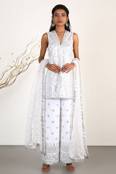 Ivory kurta with all-over mirror work and thread embroidery. Paired with palazzo pant and dupatta.
Component: 3
Embroidered
Neckline: V-Neck
Sleeve Length: Sleeveless
Fabric: Kurta: Cotton Silk; Palazzo: Cotton Silk; Dupatta: Net
Color: White
Front potli placket
Embroidery on the palazzo pant
Drawstring detail - Aza Fashions Gopi Vaid, Kurta Cotton, Designer Lehengas, White Kurta, Designer Anarkali, Kurti Designs Party Wear, Embroidered Neckline, Net Dupatta, Indian Fashion Designers