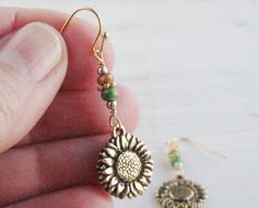 I created these delightful drop earrings in the colors of a golden autumn sunflower, with Picasso seed beads in natural and green, from which I have suspended double-sided antique gold plated sunflower charms made in the USA. The French hook ear wires are gold tone plated (nickel free) and include earring backs. These earrings measures 1 3/4 inches from the top of the earwire to the bottom of the sunflower. This is a great length as they are long enough to be seen but are still lightweight. The Adjustable Gold Sunflower Earrings, Hypoallergenic Gold Bohemian Beaded Earrings, Gold Sunflower Adjustable Flower Earrings, Bohemian Sunflower Earrings For Gift, Bohemian Sunflower Earrings As Gift, Bohemian Sunflower Design Earrings For Gift, Gold Sunflower Dangle Jewelry, Bohemian Sunflower Design Flower Earrings As Gift, Bohemian Sunflower Drop Earrings