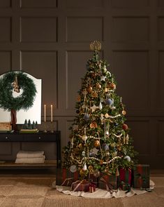 a decorated christmas tree in front of a mirror