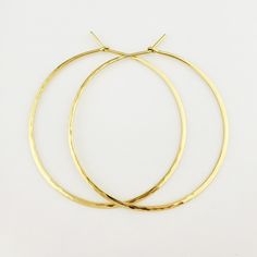 "Gorgeous Hammered Solid 18k Hoops made from 16 gauge (1.3mm) wire. 2\" Size photographed; 2\" size in 14k yellow gold shown in video METAL: Solid 18k Yellow Gold WIRE GAUGE/DIAMETER: 16 gauge (1.3mm) wire - Currently the thickest wire I offer EAR WIRE THICKNESS: Due to the thickness of the wire, the ear wire portion of the hoops will be tapered to approximately 18g, which is slightly thicker than standard ear wire thickness HAMMERED EFFECT: Each earring is made as a mirrored pair and the textur Hammered 14k Gold-filled Hoop Earrings, Hand Forged Yellow Gold Hoop Earrings, Nickel Free Yellow Gold Hoop Earrings For Wedding, Yellow Gold Round Hoop Earrings For Celebration, Hand Forged 14k Gold Filled Gold Earrings, Hand Forged 14k Yellow Gold Filled Earrings, Handmade 14k Yellow Gold Hoop Earrings, Gold-plated Yellow Gold Hoop Earrings For Celebrations, Hand Forged Elegant Hoop Earrings As Gift