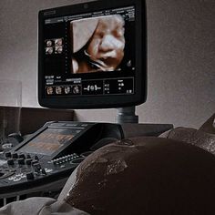 a television sitting on top of a table next to a remote control