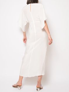 Crafted from 100% silk, the Katherine Maxi Dress features an empire waistline, a plunging neckline with a discreet hook and eye closure, half kimono sleeves, and an elegant wrap skirt. This chic silhouette is ideal for weddings, cocktail parties, and more. Note: We can also make it in off white / ivory / champagne The price $695.00 is for the light weight silk. Price will depend upon the weight of the silk, contact us for more information we can also send swatches. info@jalineresort.com Jaline i Half Kimono, Open Front Skirt, Katherine Dress, White Silk Dress, Poncho Dress, Nyc Dresses, Silk Dress Short, Silk Wrap Dresses, Floral Dresses Short