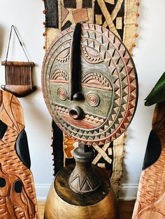 a wooden sculpture sitting on top of a table next to other wood carvings and decorations