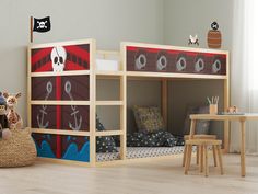 a child's bedroom with bunk beds and pirate themed wall decals on the walls