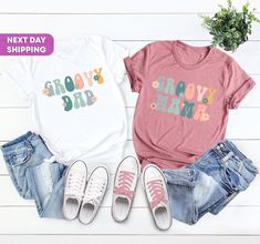 "Hi, Welcome to FashionxTee Two Groovy Family Matching Shirts, Groovy Mama, Groovy One, Groovy Birthday, Birthday Groovy Retro Wild Shirts, Retro Camp Girl Birthday Our soft and comfortable shirts are printed, pressed and shipped to you from our boutique. Enjoy your shopping!🛍️  ✔️Please make sure you check our size cards before you place your order. 📏 ✔️Please send me a message for all your questions and suggestions. It is my pleasure to assist you! **Group t-shirts are not sold as a set. The Trendy Birthday T-shirt For Spring, Spring Birthday Custom Print Tops, Trendy T-shirt For Spring Birthday, Casual Spring T-shirt For Birthday, Spring Birthday Tops With Text Print, Fun Spring Tops With Name Print, Casual Spring Birthday T-shirt, Casual T-shirt For Birthday In Spring, One Groovy Birthday