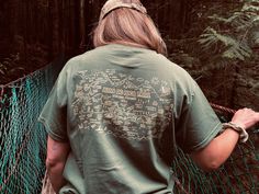 Hand drawn Juan de Fuca Trail Map printed on a 100% Cotton T-shirt, designed an produced in Port Renfrew, Vancouver Island. Reminisce on your hiking adventure! This intricately drawn map captures the essence of the amazing highlights found along this stunning coastal hike, recapturing all your memories on trail. This product is made especially for you at Childs Collective custom printing in Port Renfrew, which is why it takes us a bit longer to deliver it to you. If I don't have your size in sto Green Crew Neck Top For Adventure, Green Crew Neck Top For Camping, Green Cotton Tops For Camping, Green Screen Print Top For Adventure, Relaxed Fit Screen Print Tops For Outdoor Activities, Green Short Sleeve Top For Camping, Custom Print Short Sleeve Tops For Camping, Adventure Short Sleeve Shirt With Screen Print, Short Sleeve Screen Print Adventure Shirt