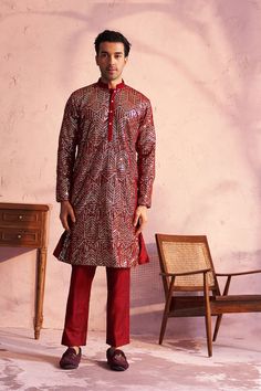 SHRESTHA BY VASTRAMAY Men's Maroon Georgette Embellished Kurta Pant Set This maroon georgette kurta pant set features intricate embellishments and a comfortable fit. The kurta has a mandarin collar, long sleeves, and a straight knee-length cut. The pants are made from viscose and have an elasticated waistband for easy wear. Dry clean only. Key Features Maroon georgette kurta with embellishments Mandarin collar Long sleeves Straight knee-length cut Solid cream viscose pants Elasticated waistband Georgette Kurta, Kurta Pant Set, Kurta With Pants, Sleeves Top, Sleeveless Jacket, Full Sleeves, Pant Set, Product Images, Mandarin Collar