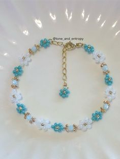 a blue and white beaded bracelet with flowers