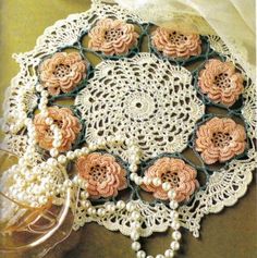 crocheted doily with flowers and pearls