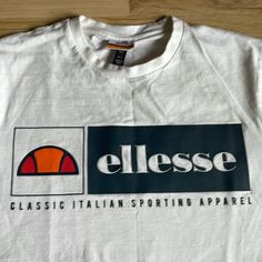 New Without Tags! Ellesse White Logo T Shirt Size Large White Casual T-shirt With Front Logo, Front Logo Top For Summer Streetwear, White Graphic Tee With Front Logo, White Crew Neck Top With Front Logo, Summer Streetwear Top With Front Logo, Sporty Crew Neck Top With Front Logo, Casual White T-shirt With Front Logo, Casual Summer Tops With Front Logo, Navy Man