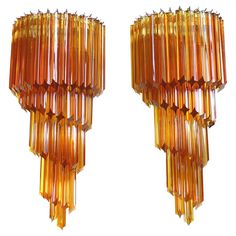 two orange glass chandeliers hanging from the ceiling