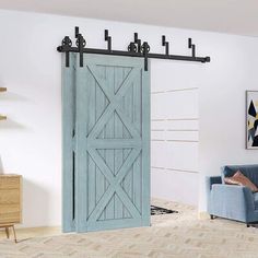 a living room with a blue couch and wooden sliding barn doors in it's center