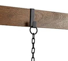 a close up of a wooden beam with chains hanging from it's sides and two lights on each side