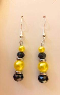 Black and yellow bead dangle earrings  Silver plated hypoallergenic earring hooks Black And Yellow Beaded Earrings, Party Jewelry With Yellow Ear Wire, Yellow Jewelry With Ear Wire For Party, Yellow Hoop Earrings With Dangling Beads, Yellow Beaded Drop Earrings, Yellow Jewelry With Dangling Beads For Party, Elegant Yellow Beaded Earrings For Gift, Yellow Dangle Earrings With Ear Wire, Yellow Ear Wire Party Earrings