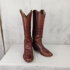 The Stewart Boot Company makes very high end and high quality boots in Tucson, Arizona. This is a very nice pair made in 1977.  Thick milk chocolate brown uppers and shafts....thick beige leather linings and stacked leather heels and thick soles. Condition is very good vintage. Some signs of previous wear as expected....with some minor blemishes. The boots are about 16 inches tall including a 2 inch heel. The opening at the top is about 14 1/4 inches. Women's size 5 B (standard width) Vintage Vegetable-tanned Leather Boots, Brown Wide Calf Boots For Ranch, Wide Calf Brown Boots For Ranch, Western Brown Snip Toe Heeled Boots, Brown Wide Calf Boots For Western-themed Events, Classic Brown Boots For Western-themed Events, Classic Vintage Brown Boots For Western-themed Events, Western Brown Knee-high Boots With Round Toe, Classic Brown Snip Toe Boots