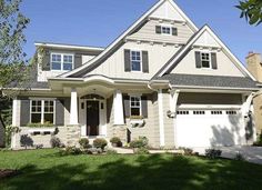 a house with white trim and gray roof