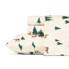 three sheets with deer and trees on them, one is folded up to the side