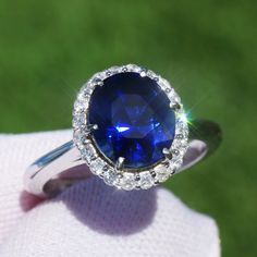 A Breathtakingly Striking HANDMADE 14k White Gold Ring with Beautiful Oval Cut Sapphire in Blue color! The GEM is 3.52CT and measures 9.42x8.12x5.94 mm! This Stone will take your breath away, especially on the sunlight! You will want to look at this stone endlessly. The mounting is a masterpiece! HANDMADE 14K White Gold Diamond Mounting (tested), that was is custom made to Accommodate this Beauty of a Gem in a V-prongs setting! Super FINE Workmanship on the Diamond v-split setting with 20 pcs Brilliant Full Cut Diamonds in GH color, SI1 clarity, totaling to approx  0.33 ct ! Fabulous Braided Band and Diamond Gallery! The Entire Top's outline is 12.6x11.2 mm- HUGE. The Ring weights 4.6 g, nice and SOLID. Sits 7.1 mm off the top of the finger. Finger size 7(Free Re-sizing with purchase). Cen Oval Gemstones With Halo Setting For Formal Occasions, Classic Oval Gemstones With Halo Setting, Classic Sapphire Gemstones With Halo Setting, Oval Sapphire Ring Gia Certified, Blue Oval Gia Certified Halo Ring, Oval Brilliant Cut Dazzling Gemstones, Gia Certified Oval Sapphire Diamond Ring, Oval White Gold Gemstones With Halo Setting, Dazzling Oval Brilliant Cut Gemstones