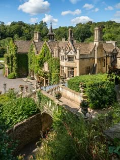 an image of a large house with lots of greenery on the front and side