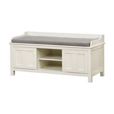 a white wooden bench with a gray cushion on it's seat and shelf underneath