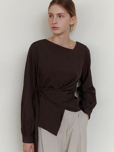 This is a refined and modern blouse by ourcomos that is made out of high quality and sturdy material. With distinctive mood of the design and comfortable wear, you can style it for your stylish and modern daily outfit.- Unbalanced diagonal neckline point- Back zipper for comfortable wear- Luxurious sea shell buttons Elegant Brown Top For Work, Modern Brown Tops For Workwear, Modern Brown Top For Work, Chic Brown Blouse For Work, Chic Brown Workwear Blouse, Chic Wrap Blouse For Work, Chic Brown Tops For Workwear, Chic Brown Tops For Work, Chic Brown Workwear Tops