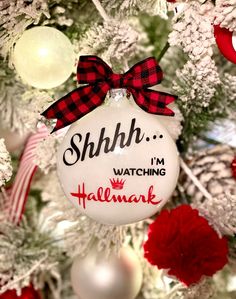 a christmas ornament that says shh i'm watching hallmark