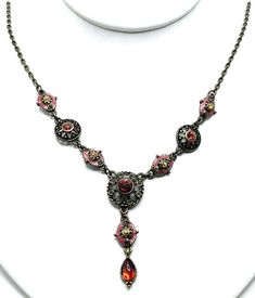 Vintage Victorian Gothic Vamp Red Enamel Bronze Austrian Crystal Y Necklace Antiqued bronze has station style details fawn pink enamel frames peach crystal, red crystal leads to a blood red moonglow dangle teardrop. 19" L with extender Great vintage condition, eclectic! Formal Red Enamel Necklaces, Formal Red Enamel Necklace, Red Enamel Round Necklace, Antique Jeweled Red Jewelry, Red Bohemian Necklace For Formal Occasions, Red Bohemian Jeweled Jewelry, Bohemian Red Jeweled Jewelry, Y Necklace, Moon Glow