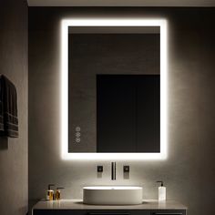 a bathroom with a sink, mirror and lights on the wall above it's counter