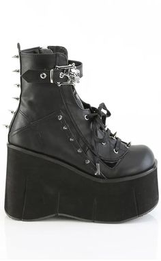 The Kera series features an impressive platform wedge across a range of styles to suit everyone who wants to tower over the competition. Vegan Black PU leather 4 1/2" Inch (114mm) Platform Lace-Up Front Ankle Boot Featuring Top Skull Buckle Strap & Metal Spike Stud Details Inner Side Metal Zip Closure U.S women's sizing-refer to size chart for more info Punk High-top Platform Boots With Reinforced Heel, Edgy High-cut Faux Leather Platform Boots, Edgy High-cut Leather Platform Boots, High-top Punk Platform Boots With Reinforced Heel, Punk High-top Leather Platform Boots, Gothic High-top Leather Platform Boots, High Cut Black Platform Boots, High Cut Platform Boots In Faux Leather, High Cut Leather Platform Boots For Streetwear