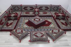 a group of red and white rugs on the floor