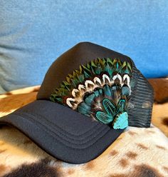 This beautiful black trucker hat with turquoise & brown feathers, and turquoise embellishment will be all anyone can talk about when you wear it.  It's such a fun way to spice up any outfit and the places to wear this hat are endless. Be prepared for loads of compliments.  The feathers are handpicked for each hat.  The hat has a foam front, mesh back, and an adjustable snap back. Feather Trucker Hat, Painted Trucker Hats, Hat Customization, Hats Trucker, Country Hat, Duck Hat, Diy Hats, Trendy Hats, Native Fashion