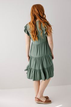 Introducing the 'Paloma' midi dress! This midi dress is in a stunning jade color and features a beautiful tiered silhouette. Carrying both comfort and feminine grace, this dress is a great addition to your warm weather closet! Pair with brown sandals and a tote bag for a casual day out or a brunch with friends. 70% Rayon 30% Linen Wash Inside Out Wash Cold Gentle Cycle Do Not Bleach Hang to Dry Low Iron if Needed Do Not Dry Clean Partially Lined Great petite length option! Model Height 5'6" | We Flowy Midi-length Ruffle Dress, Green Tiered Midi Dress For Brunch, Green Tiered Skirt Midi Dress For Brunch, Green Tiered Dress For Brunch, Flowy Knee-length Midi Dress With Ruffles, Tiered Dress With Ruffles, Green Midi Dress For Brunch, Solid Color Tiered Dress For Summer, Green Tiered Ruffle Dress With Ruffle Hem