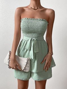 Show off your style in this Trim Shirred Belted Tube Romper. This romper features a strapless neckline, sleeveless design, and high-waisted fit for an ultra-flattering look. The mint green color is complemented by the contrast lace, frill, and shirred details for added charm. It is crafted from lightweight woven fabric with a slight stretch that allows you to move comfortably at all times. Plus, it comes with a matching belt to add definition to your waistline. Perfect for any special event or party, this romper will make sure you look stylish yet feel comfortable all night long! Features: Color: Mint Green Pattern Type: Plain Details: Belted, Contrast Lace, Frill, Shirred Length: Short Type: Tube Fit Type: Regular Fit Neckline: Strapless Sleeve Length: Sleeveless Waist Line: High Waist Fa Green Strapless Jumpsuits And Rompers For Beach, Green Bandeau Tube Top For Summer, Green Strapless Jumpsuits For The Beach, Green Strapless Jumpsuit For Beach, Strapless Green Jumpsuit For The Beach, Casual Strapless Jumpsuit For Summer Date Night, Trendy Strapless Jumpsuits And Rompers For Spring, Green Strapless Jumpsuit For Summer Vacation, Green Bandeau Summer Dress