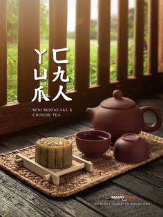 an advertisement for the mooncake and chinese tea set on a wooden deck with grass in the background